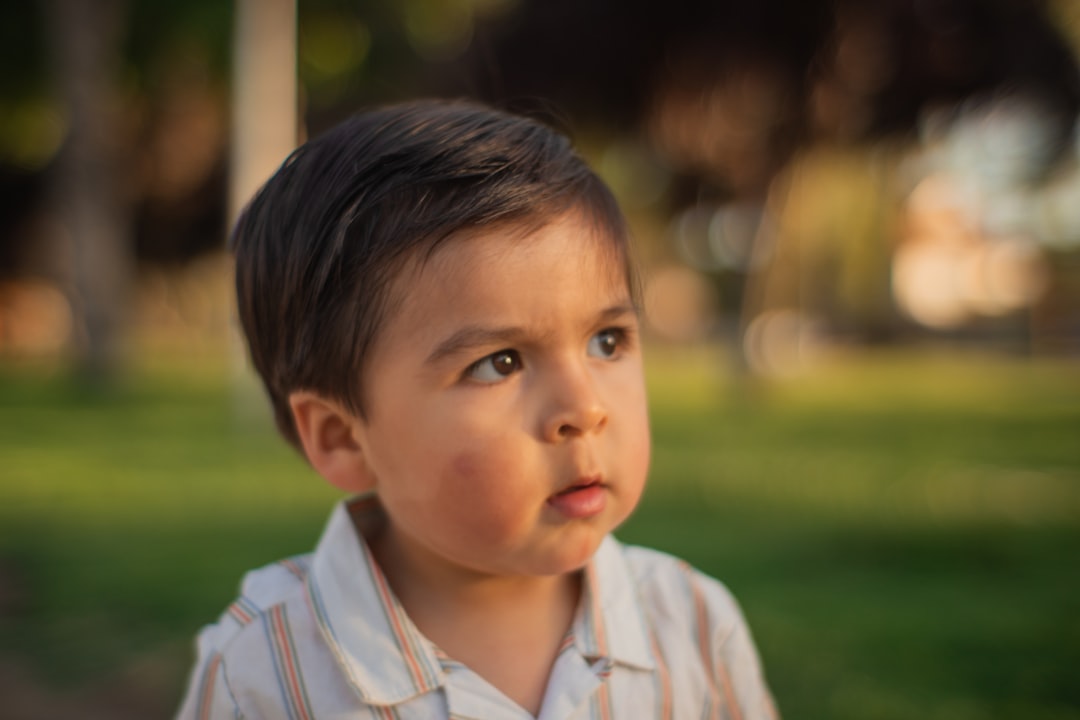 a little boy that is standing in the grass